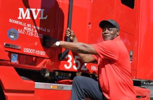 Truck driver climbing into his MVL truck cab