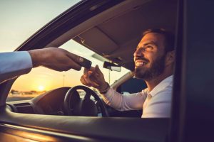 Man receiving keys to rental car