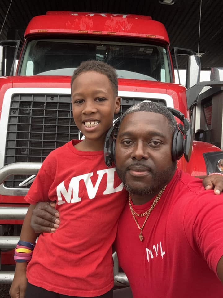 Willie Warren with his son in front of an MVL truck